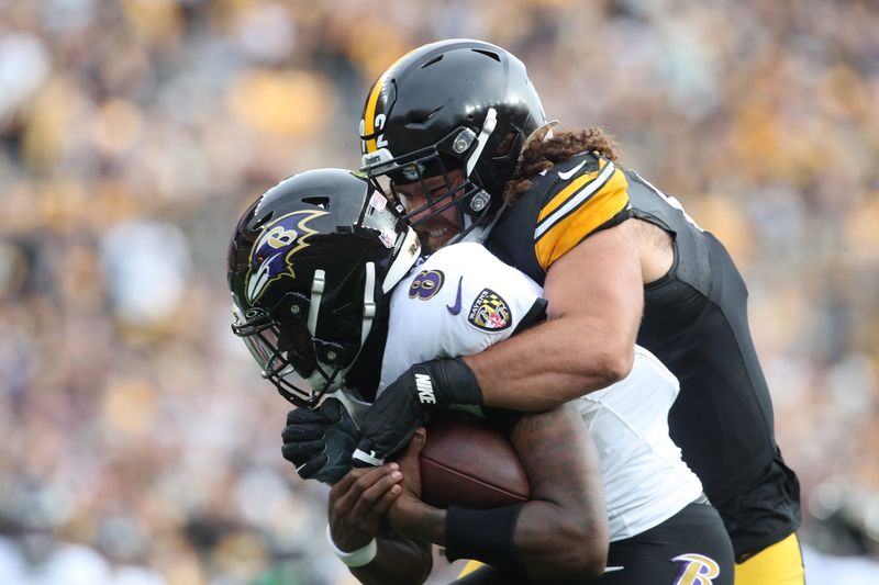 Nov 17, 2024; Pittsburgh, Pennsylvania, USA; Pittsburgh Steelers defensive tackle Isaiahh Loudermilk (92) raps up Baltimore Ravens quarterback Lamar Jackson (8) during the second quarter at Acrisure Stadium. Mandatory Credit: Charles LeClaire-Imagn Images