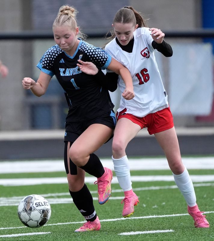 Xavier's Sydney Neilitz, left, battles for possession of the ball with Seymour's Faith Steltz during a game earlier this season in Appleton.