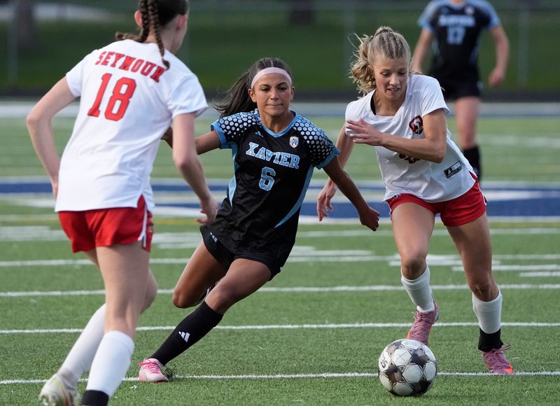 Xavier High School's Gabby Wasco (6) pursues the ball against Seymour High School's Bree Schuetttpelz (2) during their girls soccer gameThursday, May 21, 2026, in Appleton, Wisconsin. Xavier won 4-0.