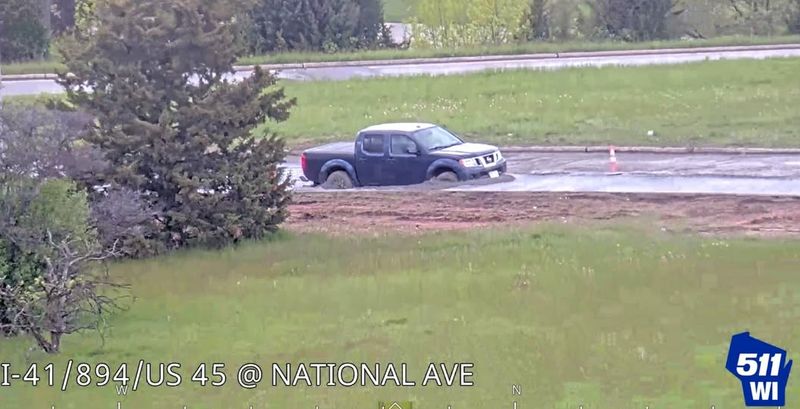 A truck drives through wet concrete on the National Avenue Interchange project.