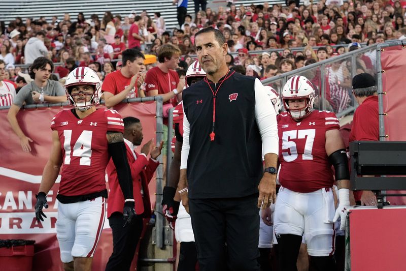 Aug 28, 2025; Madison, Wisconsin, USA; Wisconsin Badgers head coach Luke Fickell walks onto the field for warmups prior to the game against the Miami (OH) RedHawks at Camp Randall Stadium. Mandatory Credit: Jeff Hanisch-Imagn Images