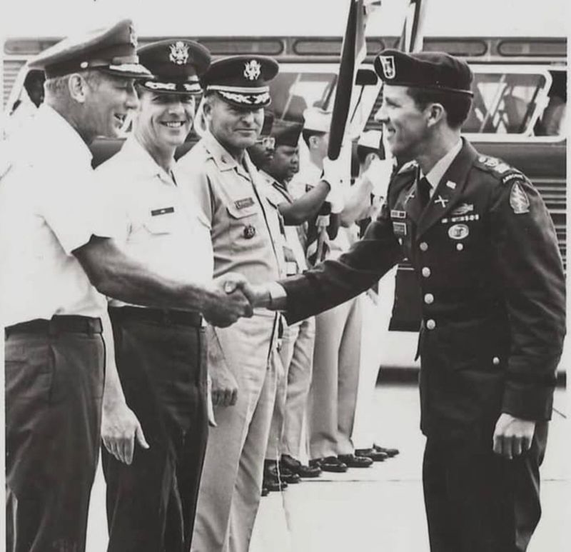 Stephen Leopold, right, greets officers at Clark Air Force Base in the Philippines in 1973, days after his release from a North Vietnamese prisoner of war camp where he had been held for five years. He is wearing the green beret uniform presented to him at the base.