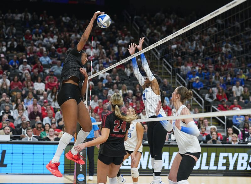 Dec 18, 2025; Kansas City, MO, USA; Wisconsin Badgers middle blocker Carter Booth (52) hits the ball during the fourth set against the Kentucky Wildcats in a 2025 NCAA Womenâ€™s Volleyball Championship semifinal match at T-Mobile Center. Mandatory Credit: Jay Biggerstaff-Imagn Images