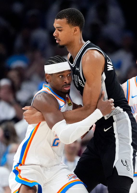 Oklahoma City's Shai Gilgeous-Alexander (2) defends against San Antonio's Victor Wembanyama (1) during Game 5 of the Western Conference Finals between the Oklahoma City Thunder and the San Antonio Spurs at Paycom Center in Oklahoma City, May 26, 2026.
