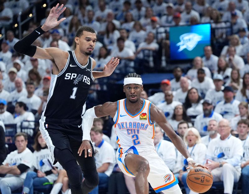 Oklahoma City's Shai Gilgeous-Alexander (2) looks to get around San Antonio's Victor Wembanyama (1) during Game 5 of the Western Conference Finals between the Oklahoma City Thunder and the San Antonio Spurs at Paycom Center in Oklahoma City, May 26, 2026.