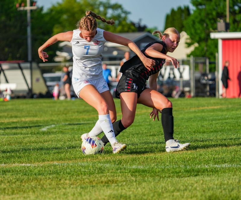 Arrowhead's Addison Nekich (7) battles for possession with Muskego's Ashlynn Scharrer (14) during the game at Muskego High School in Muskego, Wisconsin, Tuesday, May 26, 2026. Muskego won the game, 1-0.