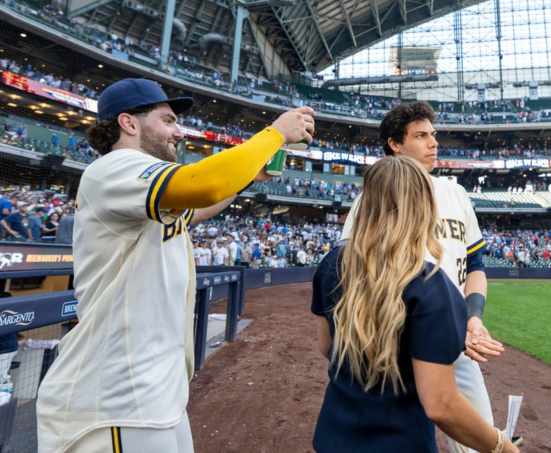 Brewers center fielder Garrett Mitchell (5) prepares to dump water over designated hitter Christian Yelich after Milwaukee's victory over the St. Louis Cardinals on May 27 at American Family Field.