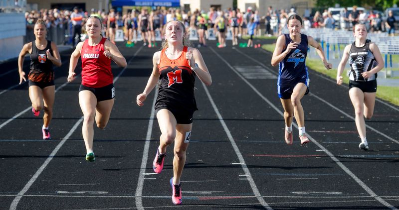Mishicot’s Juliana Doerner, center, led the pack in the 100 meter during a prelim at the Div. 3 Sectional 2 at Hilbert High School, Friday, May 29, 2026, in Hilbert, Wis.