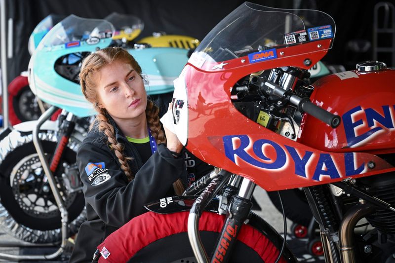 Rider Marie Madura polishes her bike before the first Royal Enfield Build. Train. Race. feature of MotoAmerica weekend May 30 at Road America.