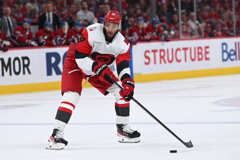 May 27, 2026; Montreal, Quebec, CAN; Carolina Hurricanes defenseman K'andre Miller (19) skates with the puck against the Montreal Canadiens during the second period in game four of the Eastern Conference Final of the 2026 Stanley Cup Playoffs at Bell Centre. Mandatory Credit: David Kirouac-Imagn Images