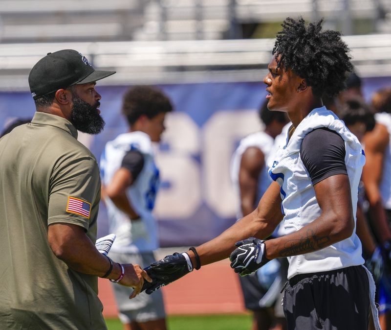 Chandler wide receiver Jai Jones (1) meets with a college coach during spring football showcase at Chandler High School in Chandler on May 12, 2026.