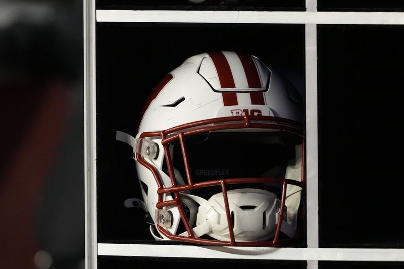 Oct 26, 2024; Madison, Wisconsin, USA; General view of a Wisconsin Badgers helmet on the sidelines during the game against the Penn State Nittany Lions at Camp Randall Stadium. Mandatory Credit: Jeff Hanisch-Imagn Images