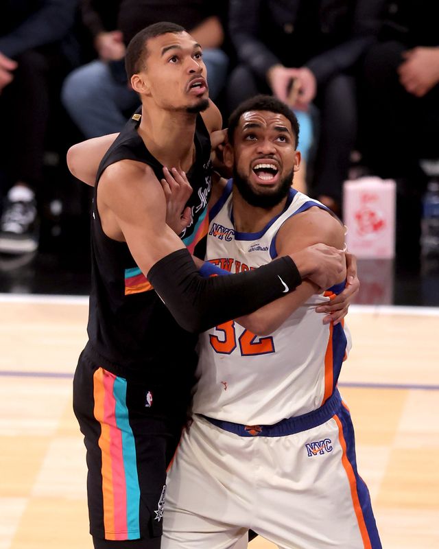 San Antonio Spurs forward Victor Wembanyama (1) and New York Knicks center Karl-Anthony Towns (32) fight for a rebound at Madison Square Garden on March 1, 2026.