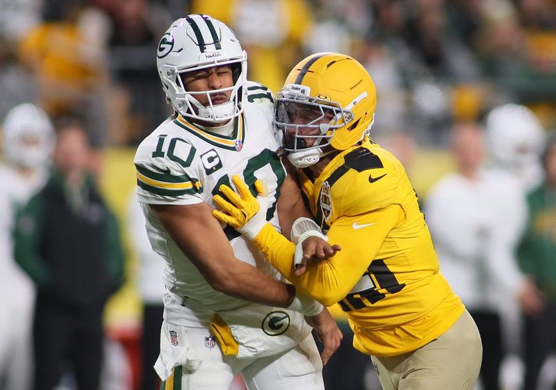 Green Bay Packers quarterback Jordan Love (10) narrowly gets rid of the ball before being tackled by Pittsburgh Steelers linebacker Nick Herbig (51) during the second half at Acrisure Stadium in Pittsburgh, PA on October 26, 2025.