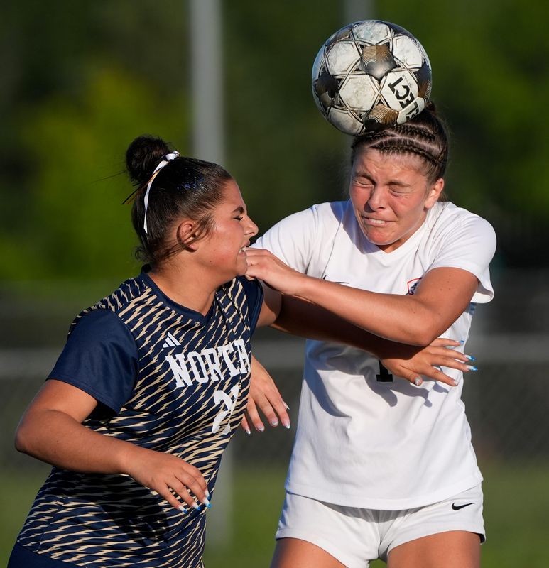 Appleton East High School's Ella Mielke (1) heads the ball against Appleton North High School's Emily Apostolou (21) during their WIAA Division 1 regional semifinal girls soccer game Tuesday, June 2, 2026, at Appleton North High School in Appleton, Wisconsin. Appleton North won 7-0.