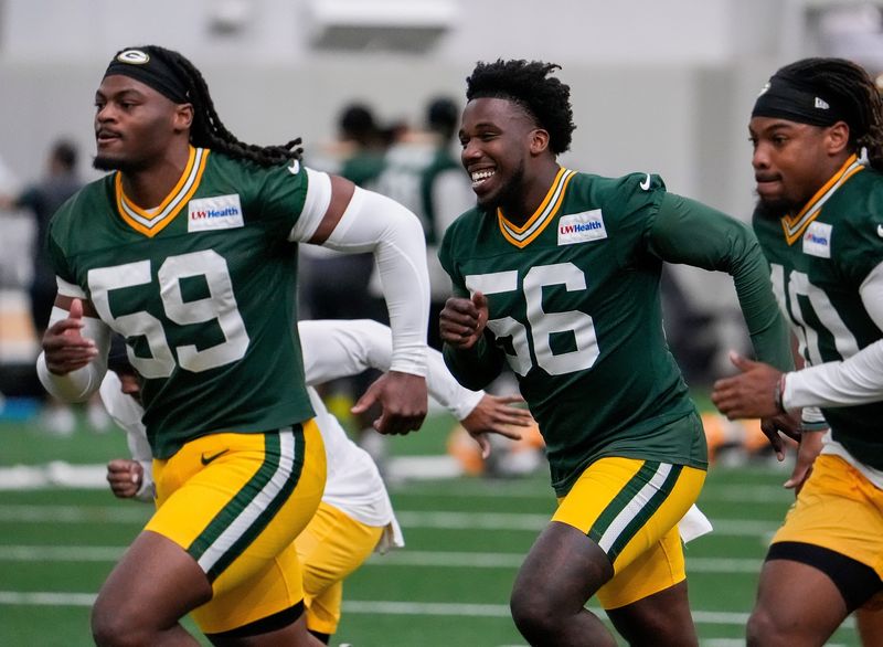 Green Bay Packers linebacker Edgerrin Cooper (56) smiles as he runs through warm-ups during practice on Tuesday, June 2, 2026, at the Don Hutson Center in Ashwaubenon, Wis. 
Tork Mason/USA TODAY NETWORK-Wisconsin