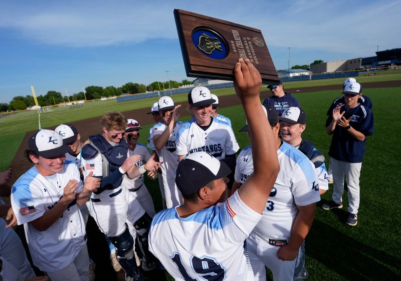 Little Chute High School players celebrate their victory against Denmark High School during their WIAA Division 2 regional final baseball game Wednesday, June 3, 2026, in Little Chute, Wisconsin. Little Chute won 4-2.