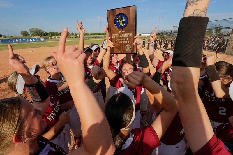 The New Holstein softball team celebrates the WIAA Division 3 sectional championship win on June 4 in Wrightstown.