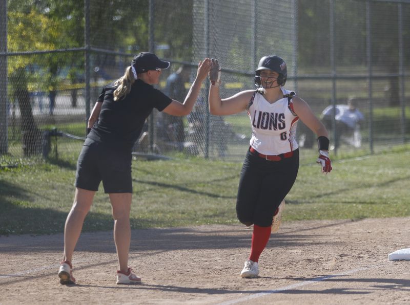 Lomira's Lily Christian (right) high fives head coach Stacey Clark after a home run against Clinton in the Division 3, Sectional 4 championship game at Taylor Park in Rosendale on Thursday, June 4, 2026. Lomira defeated Clinton 11-0 in five innings.