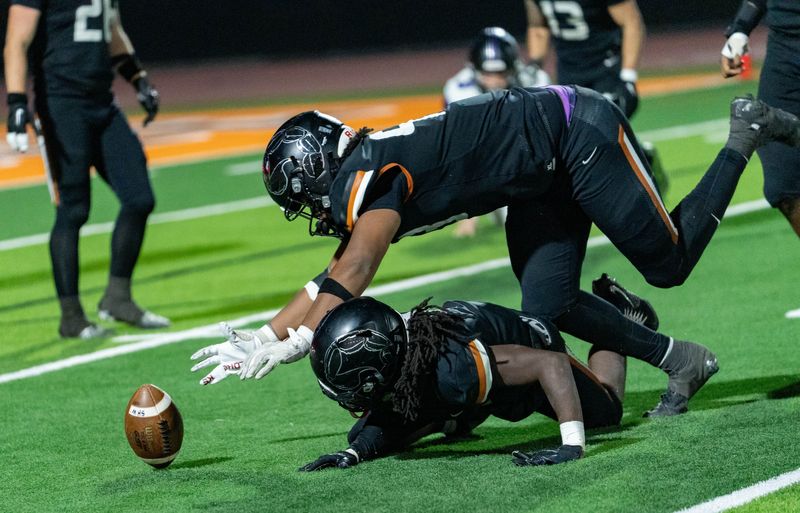 Desert Edge Scorpions Yahzeen Zion (93) jumps over Marshawn Coleman (9) to get to the ball during a game against the Millennium Tigers at Desert Edge High School in Goodyear on Oct. 31, 2025.