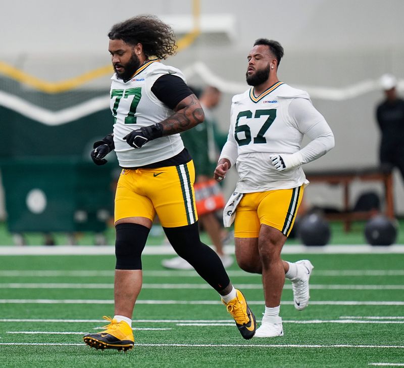 Green Bay Packers offensive tackles Jordan Morgan and Donovan Jennings warm up during the first day of a three-day minicamp.