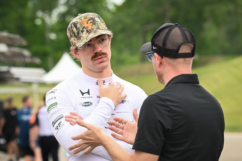 Louis Foster talks with a member of his crew during an IndyCar test at Road America.