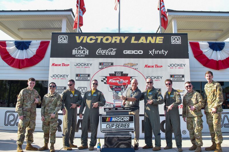 Retired U.S. Air Force Maj. Gen. Tim Zadalis (right of trophy) poses with the crew of a C-17 Globemaster III from Joint Base Lewis McChord, Washington, that performed the flyover at the 2022 NASCAR Cup Series Kwik Trip 250 at Road America in Elkhart Lake.