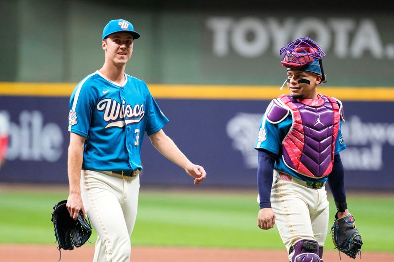 Jun 12, 2026; Milwaukee, Wisconsin, USA; Milwaukee Brewers pitcher Jacob Misiorowski (32) soaks it all in as he walks off the field with catcher William Contreras (24) after a nine innings 6-0 win over the Philadelphia Phillies at American Family Field. Misiorowski (32) pitched all nine innings of the game. Mandatory Credit: Michael McLoone-Imagn Images