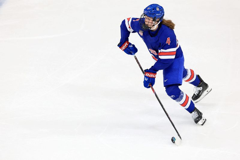 Feb 13, 2026; Milan, Italy; Caroline Harvey of United States in action against Italy in a women's ice hockey quarterfinal during the Milano Cortina 2026 Olympic Winter Games at Milano Rho Ice Hockey Arena. Mandatory Credit: Katie Stratman-Imagn Images