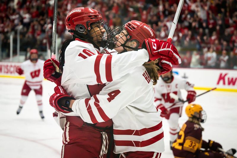 Wisconsin Badgers forward Laila Edwards, left, and defender Caroline Harvey celebrate after Edwards scored against the Minnesota Gophers in the first period in a game Saturday, February 8, 2025, at LaBahn Arena in Madison, Wisconsin.