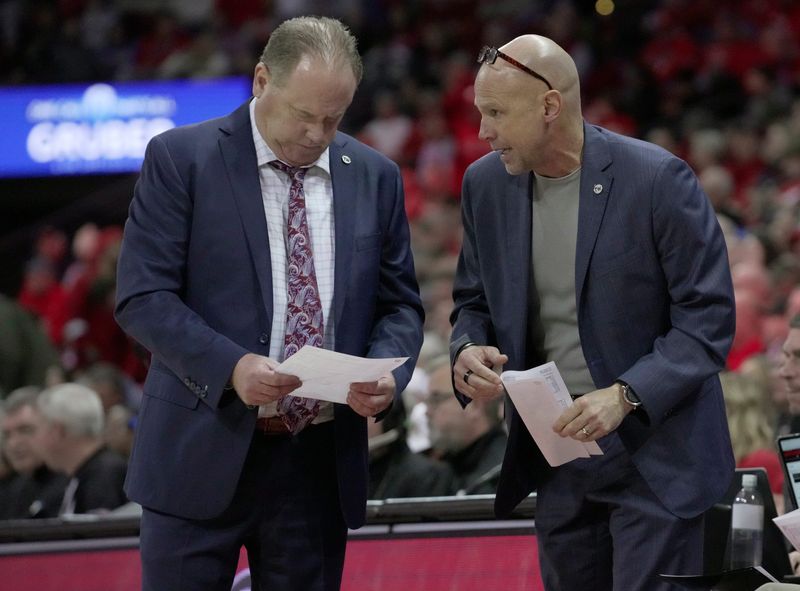 Wisconsin head coach Greg Gard, left, speaks with assistant coach :Lance Randall during the second half of their game Tuesday, January 6, 2026 at the Kohl Center in Madison, Wisconsin. Wisconsin beat UCLA 80-72.