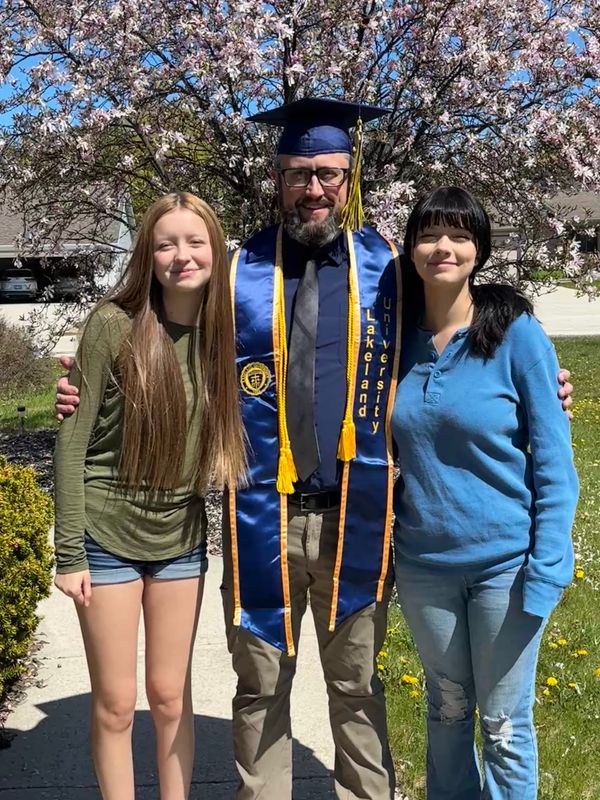 Perry Kaiser, middle, smiles with his two daughters at a Lakeland University graduation. Perry was nominated by his wife, Rianna, and one of his daughters, Luci, for the Fathers of the Year list.