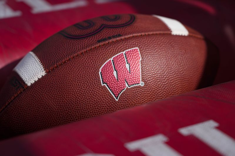 Sep 20, 2025; Madison, Wisconsin, USA;  General view of the Wisconsin Badgers logo on a football during warmups prior to the game against the Maryland Terrapins at Camp Randall Stadium. Mandatory Credit: Jeff Hanisch-Imagn Images