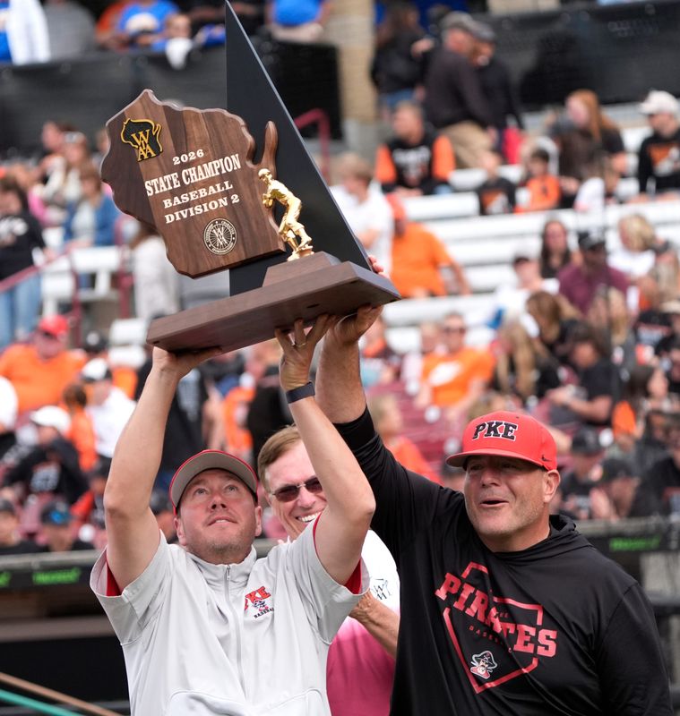 Pewaukee High School's coach Adam Dobberstein, left, and Marc Dobberstein raises the championship trophy during their WIAA Division 2 championship baseball game Thursday, June 18, 2026, at Neuroscience Group Field at Fox Cities Stadium in Grand Chute, Wisconsin. Pewaukee won 5-4.
Dan Powers/USA TODAY NETWORK-Wisconsin