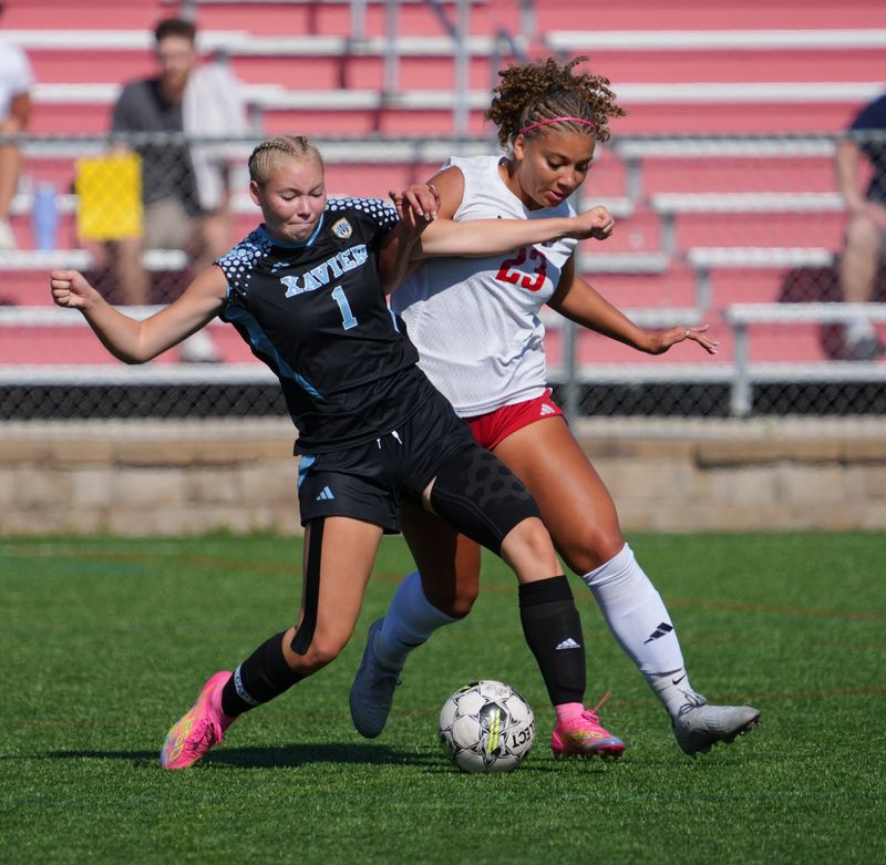 Xavier's Sydney Neilitz (1) battles The Prairie School's Keira Kimbrough (23) during the WIAA Division 4 state girls soccer championship game Saturday, June 20, at Uihlein Soccer Park in Milwaukee.