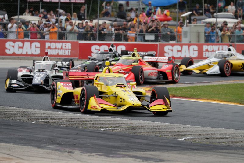 Pole-sitter Alex Palou leads the field through Turn 5 on the opening lap of the 2026 IndyCar XPEL Grand Prix at Road America.