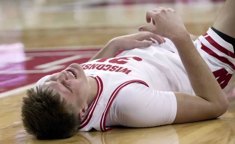 Wisconsin forward Nolan Winter (31) grimaces after being injured during the second half of their game Monday, December 22, 2025 at the Kohl Center in Madison, Wisconsin. Wisconsin beat Central Michigan 88-61.