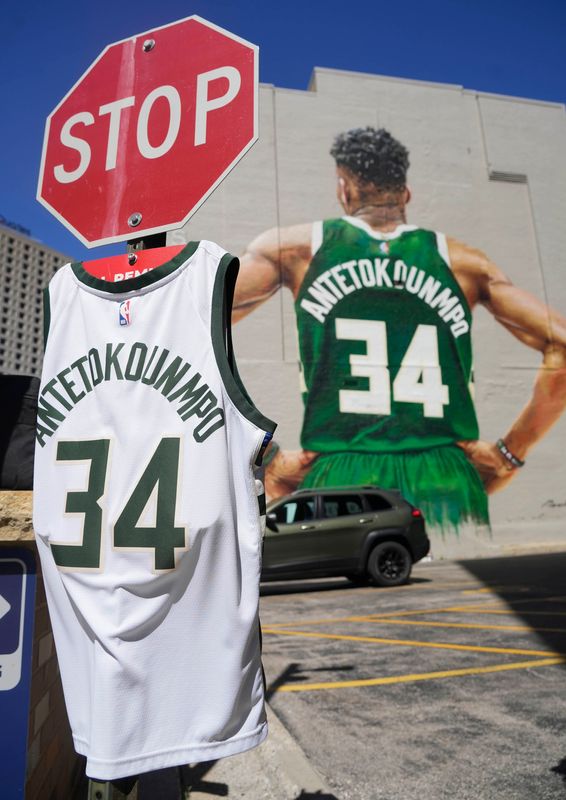 Giannis Antetokounmpo memorabilia jersey is placed on a traffic sign near a mural of the Milwaukee Bucks player at 600 E. Wisconsin Ave., on June 23, 2026, in Milwaukee, Wisconsin. It was announced today Antetokounmpo is being traded to the Miami Heat.