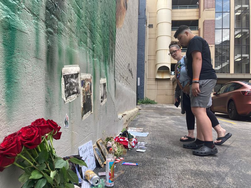 Milwaukee residents Alejandro Castillo, 15, and his mom, Kari Durr, visit the growing shrine to Milwaukee Bucks forward Giannis Antetokounmpo at his mural on East Wisconsin Avenue.