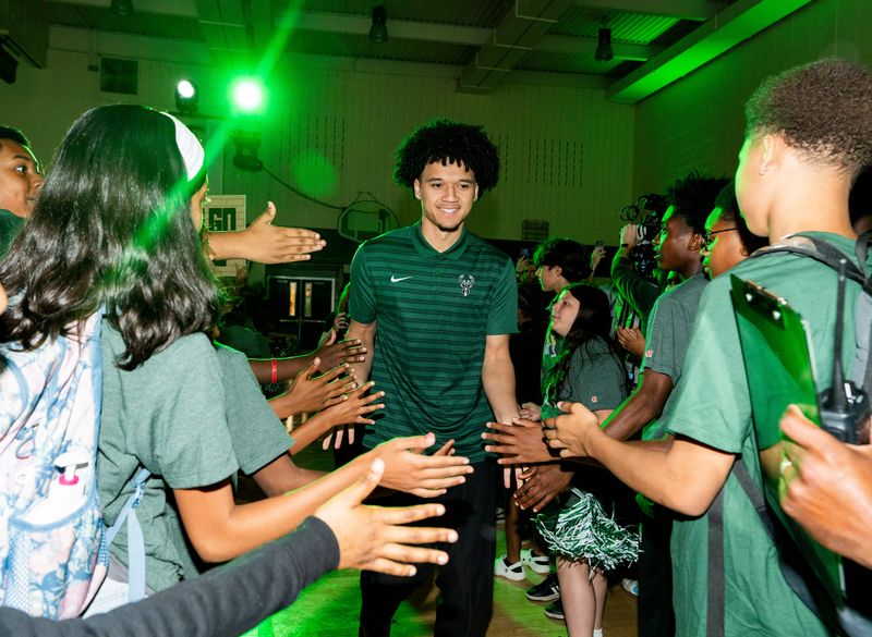 Milwaukee Bucks draft pick Brayden Burries is greeted by children as he arrives for a press conference introducing the team's newest players at the Pieper-Hillside Boys & Girls Club in Milwaukee, Wisconsin on June 25, 2026.