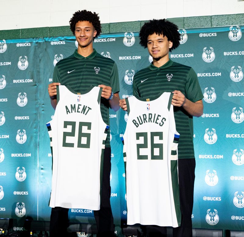 Milwaukee Bucks acquired draft pick Nate Ament, left, and draft pick Brayden Burries, right, pose for a photo holding their Milwaukee Bucks jersey after a press conference introducing the team's newest players at the Pieper-Hillside Boys & Girls Club in Milwaukee, Wisconsin on June 25, 2026.