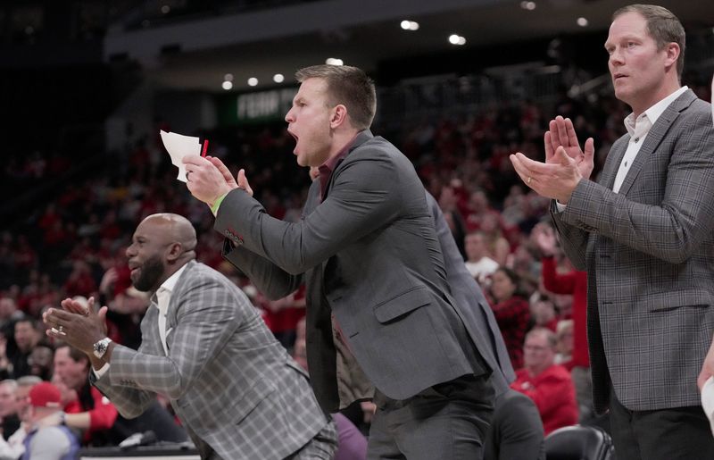Wisconsin special assistant to the head coach Brad Davison, center, is shown during the second half of their game Friday, December 19, 2025 at Fiserv Forum in Milwaukee, Wisconsin. Villanova beat Wisconsin 76-66 in overtime. At right is associate head coach Joe Krabbenhoft.