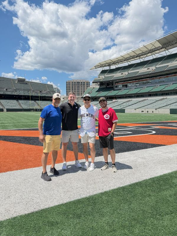 From left, Art Gamez, Bengals head coach Zac Taylor, Torie Gamez and Mateo Gamez pose on the field at Paycor Stadium on June 23, 2026, after the three Milwaukeeans happened to run into Taylor outside the stadium.
