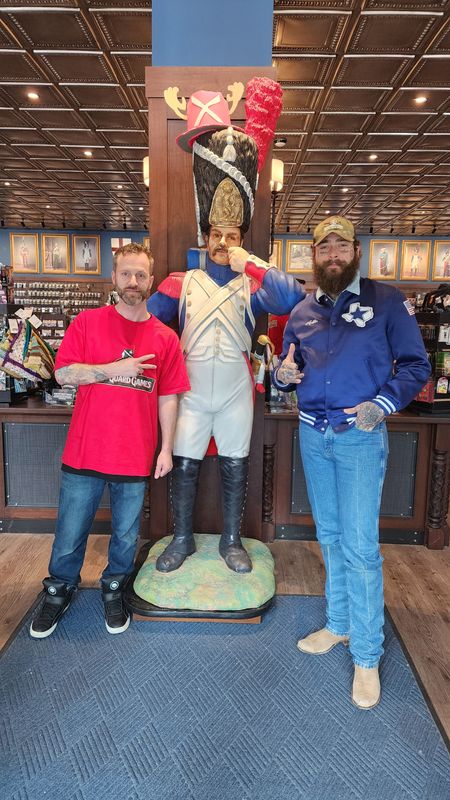 Old Guard Games general manager Josh Lowerr, left, takes a picture with rapper and singer Post Malone  at Old Guard Games, 3132 N. Downer Ave., in Milwaukee. The singer dropped in during Summerfest.