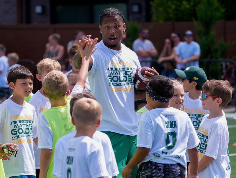 Green Bay Packers wide receiver Matthew Golden slaps hands with a camper on Saturday, June 27, 2026, at Emplify Health Field at Titletown in Ashwaubenon, Wis. The camp was held for athletes aged 6-16.
Tork Mason/USA TODAY NETWORK-Wisconsin