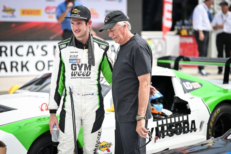 Matthew Brabham talks with his father, retired sports car champion Geoff Brabham, after winning the 100-mile Trans Am race in the Cheese Capital Cup on June 28 at Road America.
