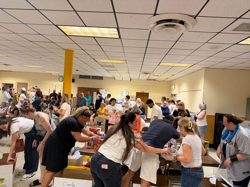 Volunteers sort and pack donations June 29 in the basement of Blessed Sacrament Catholic Church for people living in the aftermath of Venezuela's earthquakes. The "United For Venezuela" emergency relief effort is a partnership among Blessed Sacrament, the Milwaukee Brewers, Our Lady of Queen Peace Parish and Forward Latino.