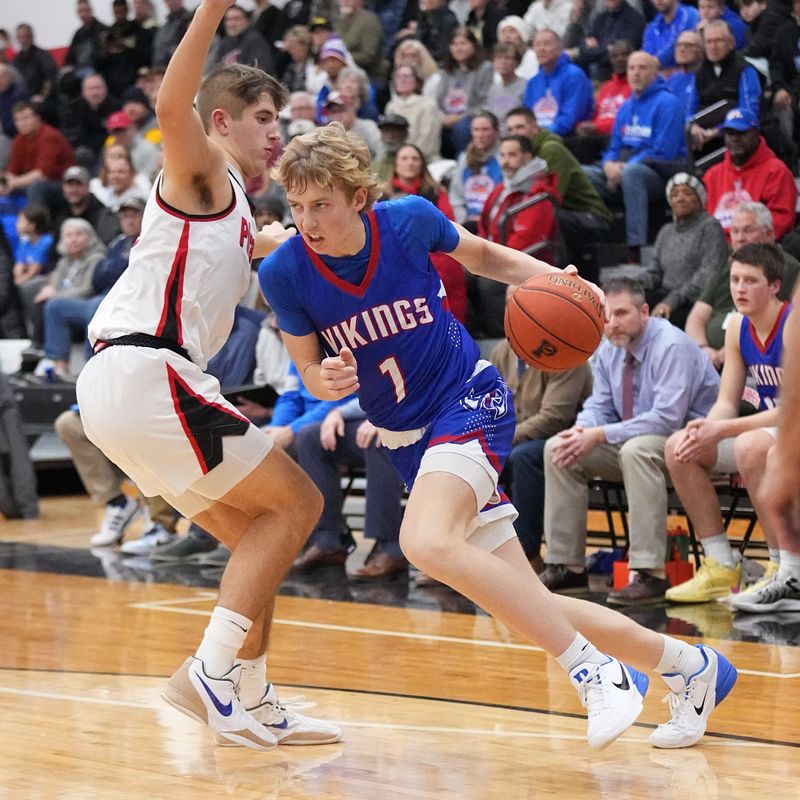 Wisconsin Lutheran's Kager Knueppel (1) breaks past Pewaukee's Tyler Tiutczenko (33) during the game at Pewaukee on Thursday, Jan. 23, 2025.
