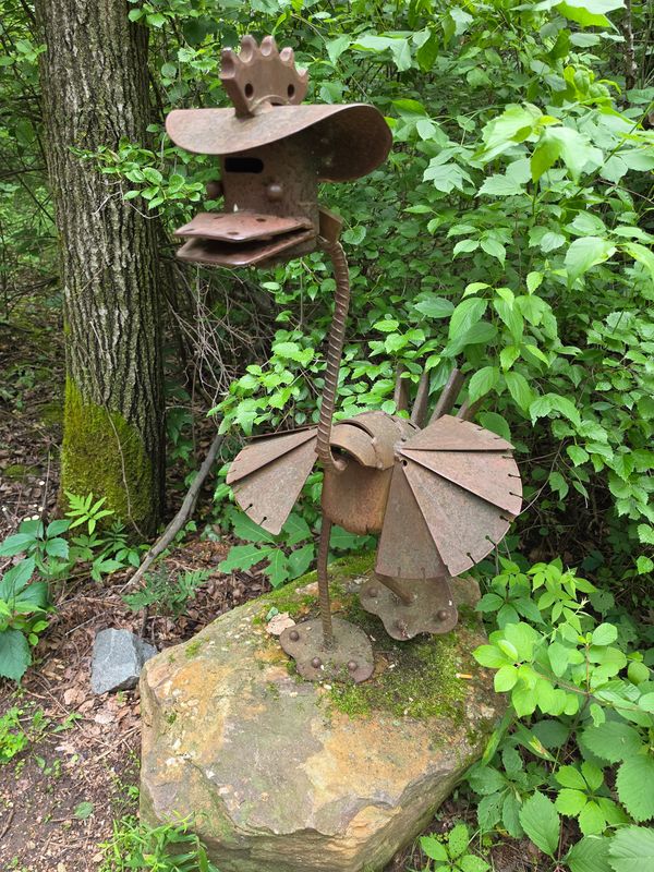 "TNIOP (that's Point spelled backwards)," 2014, by Roger M. Skrzeczkoski Sr. welcomes visitors near the park's entry and is made of old city snowblower parts, a downtown tree grate, and a police car in the Stevens Point Sculpture Park as seen on June 30, 2026.