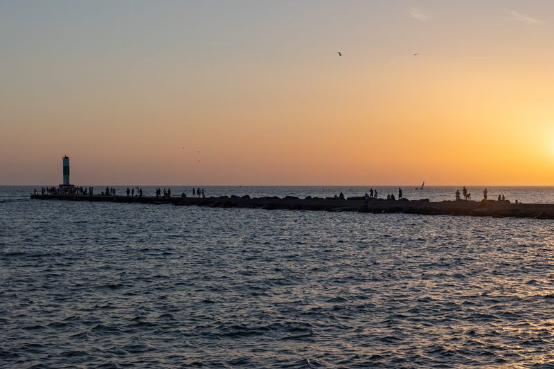 The sun sets over Lake Michigan at Holland State Park on Wednesday, July 1.